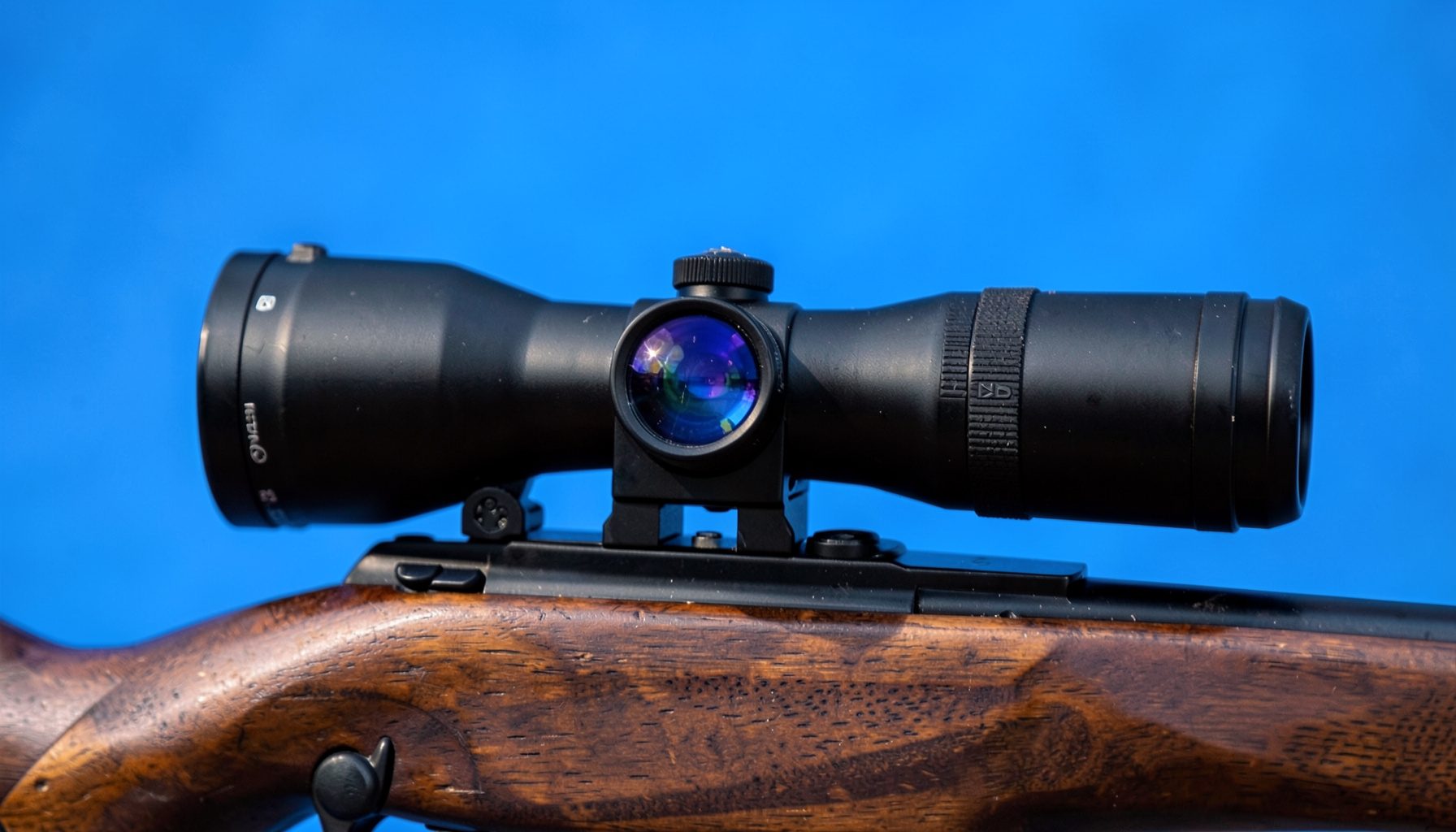 A rifle scope mounted on a bolt-action rifle, seen from a side profile with soft natural light highlighting the lens coatings